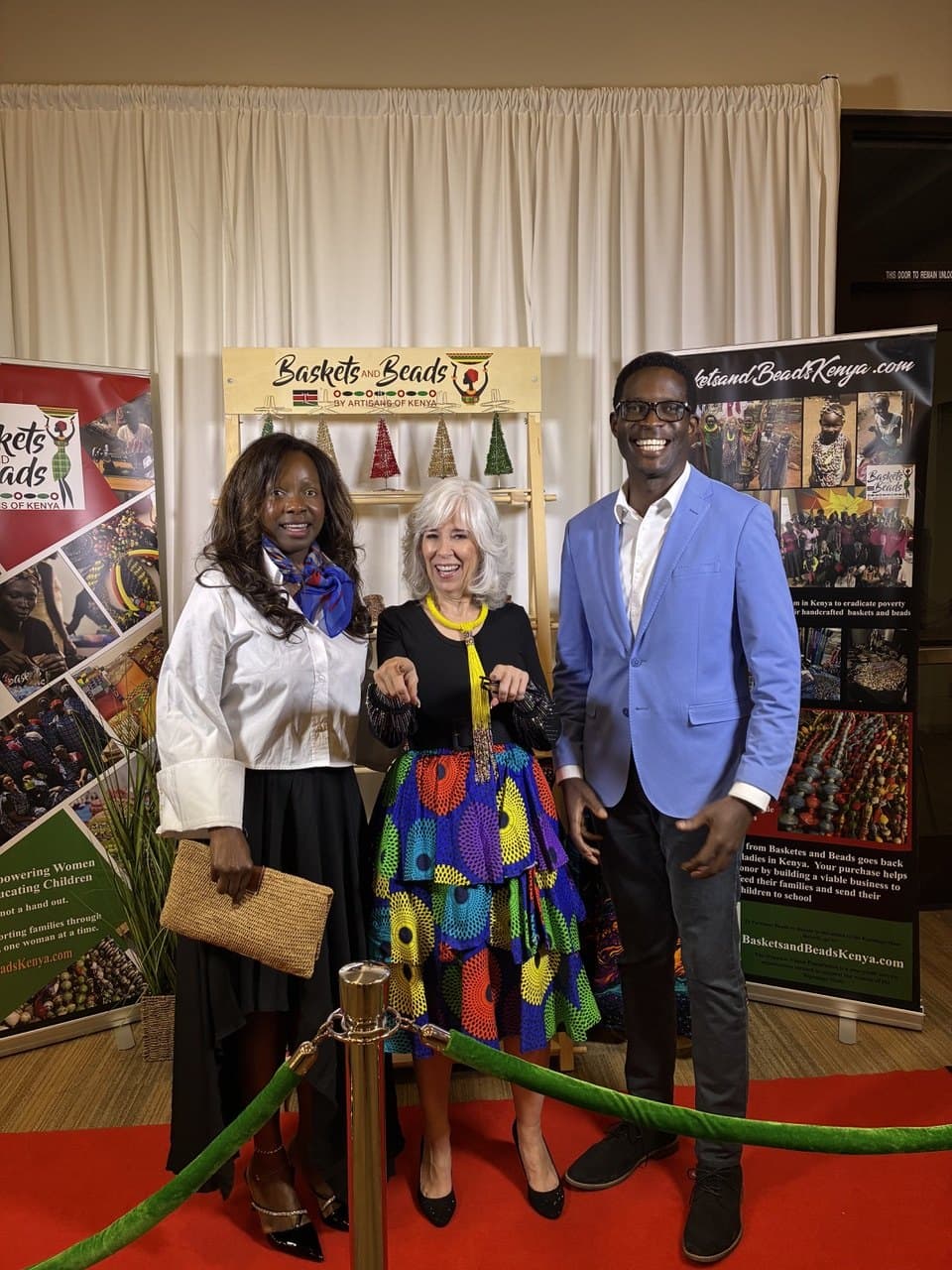 Eldonna with guests in front of the Baskets and Beads Kenya display at Celebration of Impact